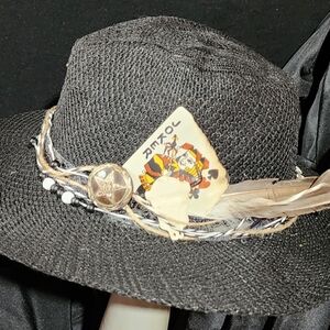 New, black straw hat with original decorations.